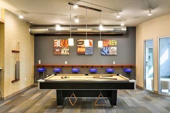 a games room with a pool table and modern artwork at Bluestone Lofts, Duluth